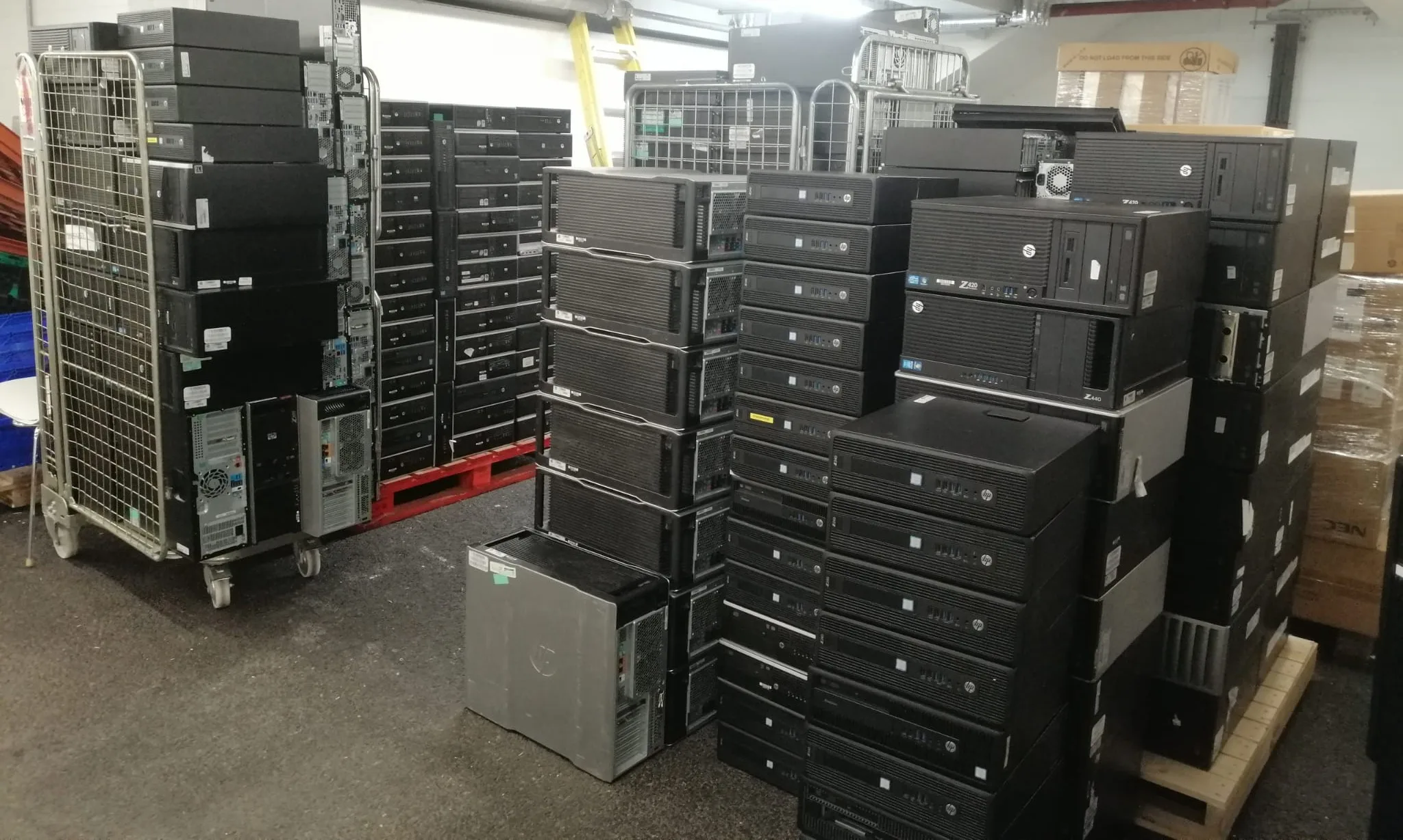 Donated desktop computers and workstations from Transport for London stacked in a warehouse awaiting shipment to The Gambia